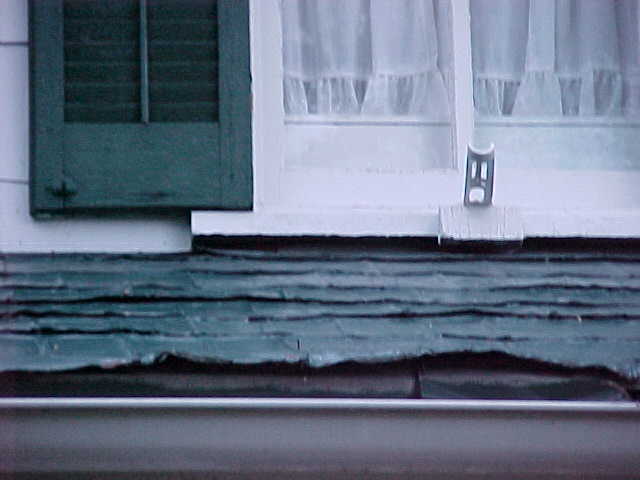 Front porch damaged tin shingles