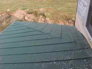 Standing seam traditional panels over front porch repaired by Roof Menders