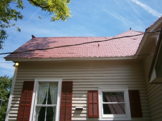 Area of red shingle roof formerly with chimney
