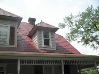 Front right view of red shingle roof