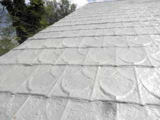 Closeup of Roof Menders work on embossed tin shingles