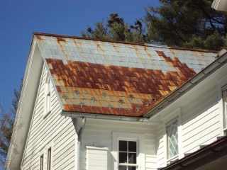 Roof Menders crew prepares to clean rusting roof to convert to silver shingles
