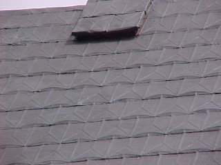Shingles coated with bronze acrylic from Preservation Products
