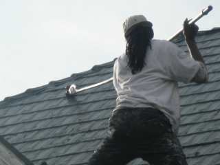Scrapping the roof of loose debris