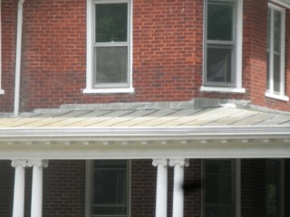 Porch roof is more recent, a standing seam panel style