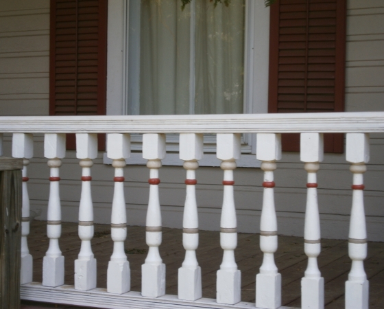 Porch features and shutters adds attractive detail