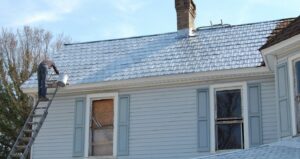 In Winston-Salem, a chocolate brown rusty roof is treated with a strong primer